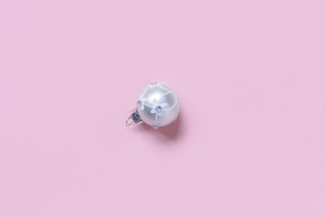 Silver Christmas bauble on a light pink background
