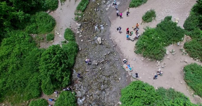 4K aerial of giant multi-tiered waterfall in the forest.