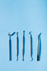 dentist tools on blue background: Dental Hygiene and Health conceptual image