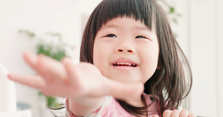 asian child raise her hand