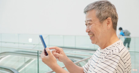 Fototapeta premium elder man use smart phone