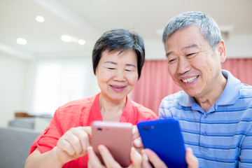 asian eldely couple use smartphone