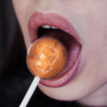 Female mouth with lollipop looks candy like a planet Mars. Digital art image, including elements furnished by NASA.