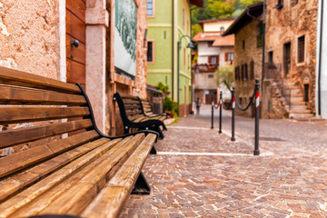 Fototapeta na wymiar Old small stone street in Italy. City of Ranzo province of Trento. The foreground in focus, the background is blurred