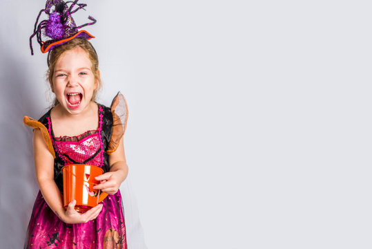 Little Cute Girl In Witch Costume For Halloween