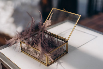 glass wedding box for engagement rings stuffed with feathers