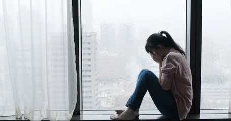 woman cry near by window