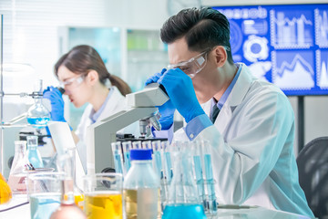 Fototapeta premium Asian scientist use microscope