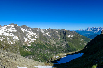 Naklejka na ściany i meble Massive mountain range of Schladming Alps, Austria. The slopes of Alps are steep, partially overgrown with green bushes. Dangerous mountain climbing.Clear and beautiful day. Endless mountain ranges,