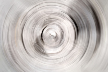 Blurred radial motion gradient white gray background. Circular brushed texture