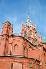 Fototapeta na wymiar Red brick church against a blue sky