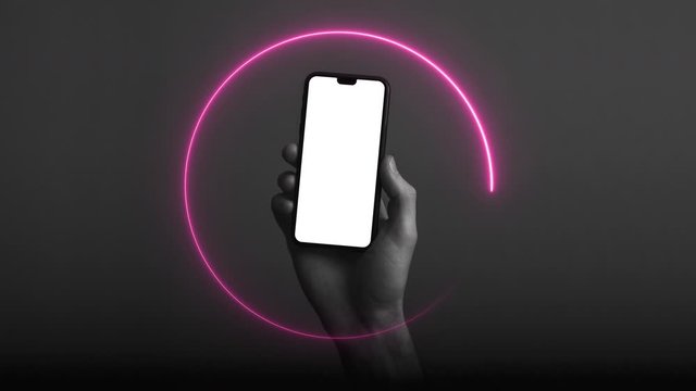 Hand holding modern smartphone with a blank white screen and neon light glow