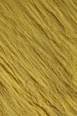 Yellow fabric mesh. Rumpled cloth background.