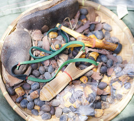 Sling shot. A wooden sling shot on wood. and a lot of seed bullets.