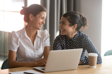 Happy millennial multiracial employees working together at office.
