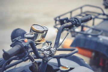 ATV racing car. A closed up of ATV racing car handle bar with soft focus on the rusty dial.