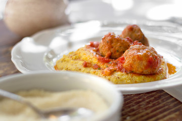 Polenta with meatballs in tomato sauce