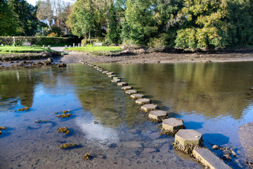 Low tide stepping stones over a river