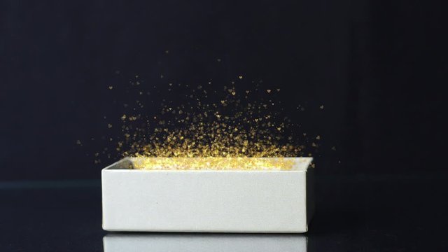 magic gift box with shining particles and hearts