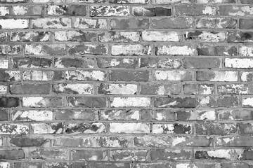 Black and white photo with image of brick wall made of old bricks with different textures