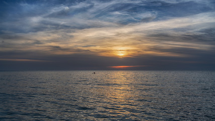 Herzliya beach and sunset over the sea with old man silhouette