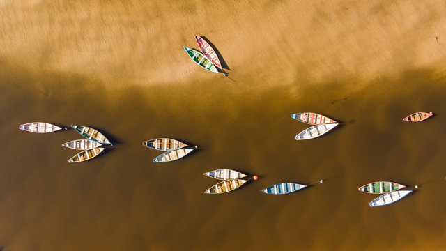 Color boats on a river from a drone view.
