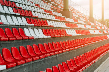Fototapeta premium Plastic seats in the stands for sports fans in the stadium.