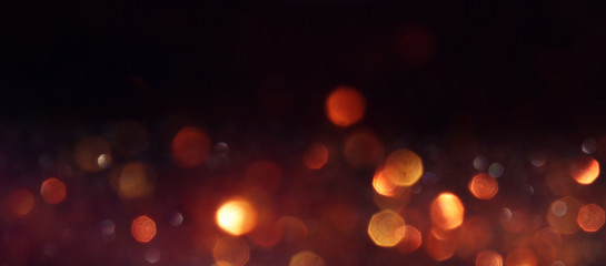 background of abstract glitter lights. gold and black. de focused. banner