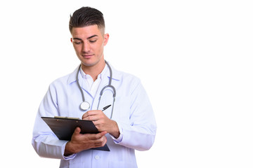 Young handsome man doctor writing on clipboard