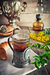 A glass of tea with thyme