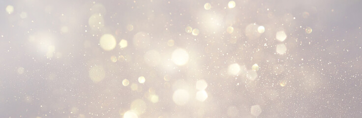 abstract background of glitter vintage lights . silver and white. de-focused