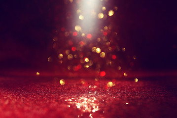 background of abstract red, gold and black glitter lights. defocused