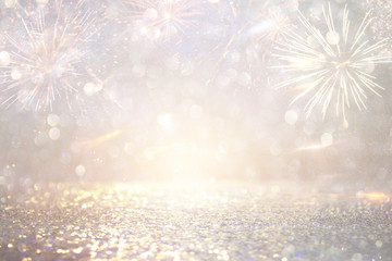 abstract gold and silver glitter background with fireworks. christmas eve, 4th of july holiday...