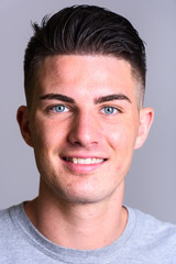 Obraz premium Face of young happy handsome man smiling with teeth