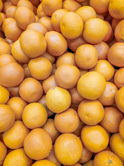 Lots of oranges . Background oranges . Fruit on the counter of the store. Huge selection of oranges.