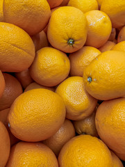 Lots of oranges . Background oranges . Fruit on the counter of the store. Huge selection of oranges.