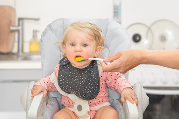 Cute little baby girl in a kitchen