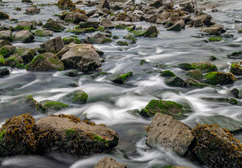 Long exposure of River Meavy water flowing over rocks at Lopwell Weir, Plymouth, Devon