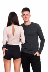 Studio shot of young couple with back view of woman