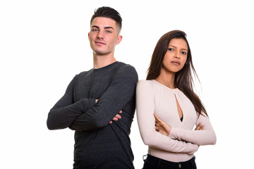 Studio shot of young couple with arms crossed together