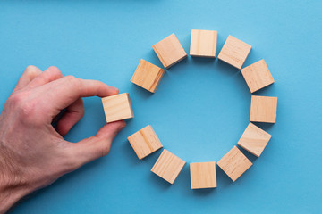 Hand choosing a wooden block from a set. Business choice concept