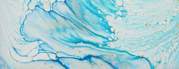 art photography of abstract marbleized effect background. white, blue and gold creative colors....