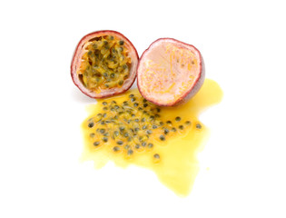 Half passion fruit with sweet pulp, seeds and juice spilled