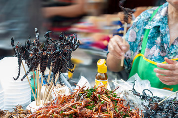 Deep fried scorpion skewers and insects, street food.