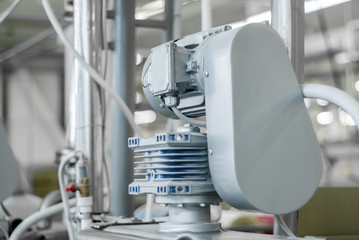 blurred industrial background with electric motor on the foreground