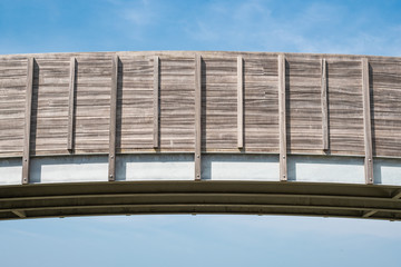Detailed, architectural view of a newly constructed, mostly timber walkway. Showing detail of the timber design and batons that make up the overall frame.