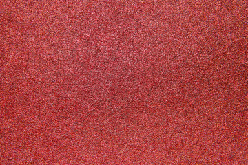 A texture of a coarse grit sandpaper
