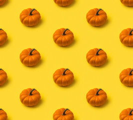 Autumn seamless pattern. Pumpkins on yellow background