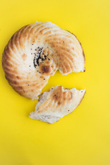 Homemade  freshly baked bread on  the yellow background. Top view. Copy space. Location vertical.