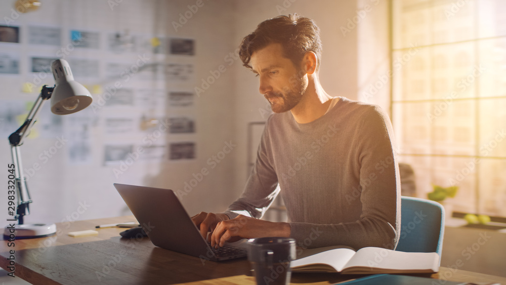 Poster professional creative man sitting at his desk in home office studio working on a laptop, concentrate